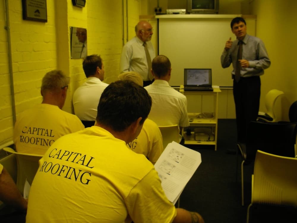 Apprentice learning roofing techniques